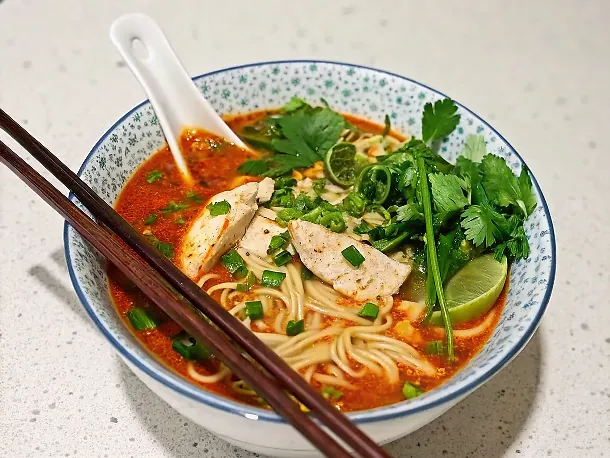 Perfectly seared 20-Minute Thai Red Curry Noodle Soup With Chicken served professional style