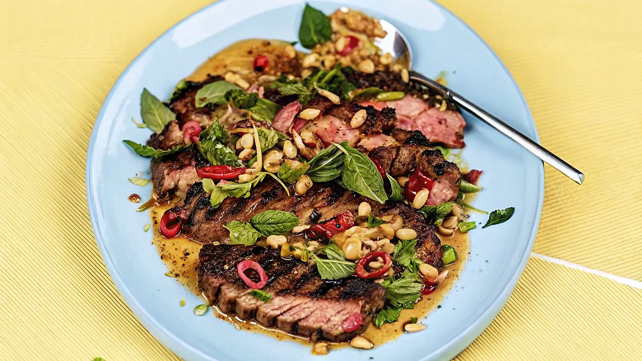 Perfectly seared Grilled Steak With Spicy Peanut Dressing served professional style